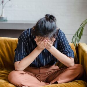 Woman feeling fatigued and low — a possible sign of hormonal imbalance