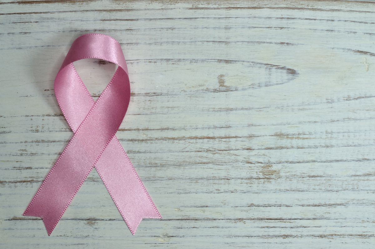 Pink awareness ribbon on a wooden surface — HRT and breast cancer risk