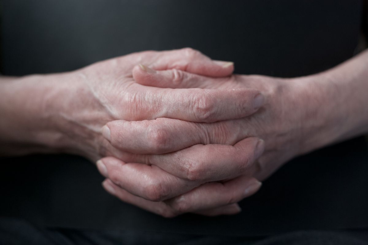 Close-up of clasped hands — joint pain linked to low estrogen
