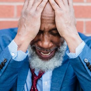 Distressed middle-aged man holding his head β low testosterone and anxiety