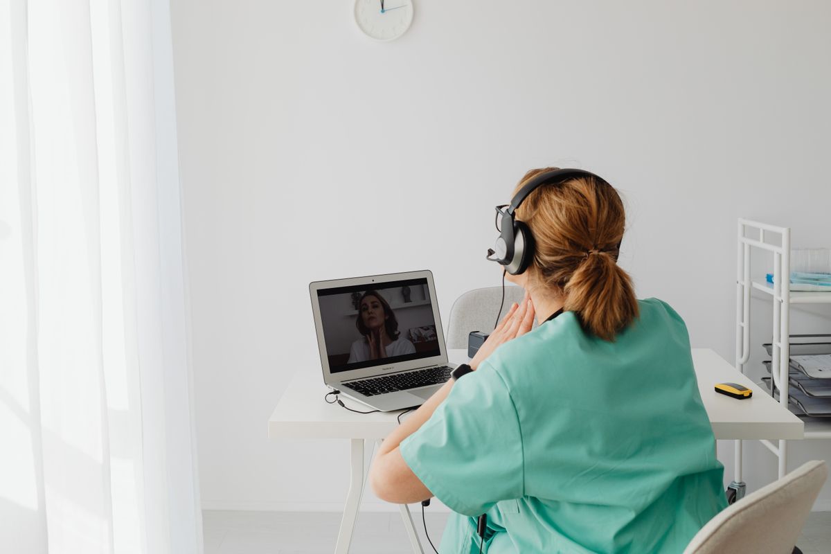 Doctor on a telehealth video call with a patient — managing semaglutide and HRT together