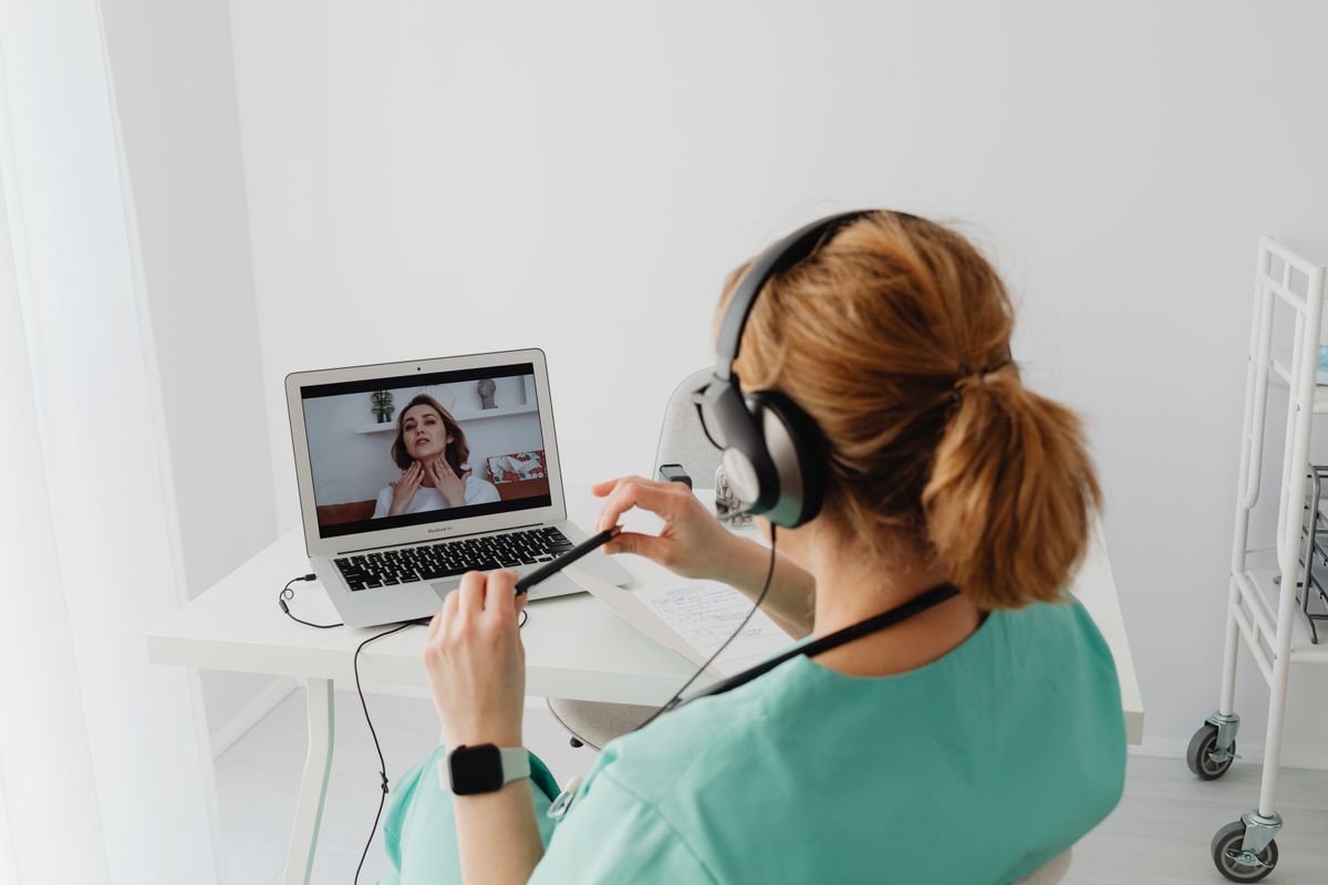 Telehealth consultation with patient describing throat and neck symptoms — thyroid or menopause